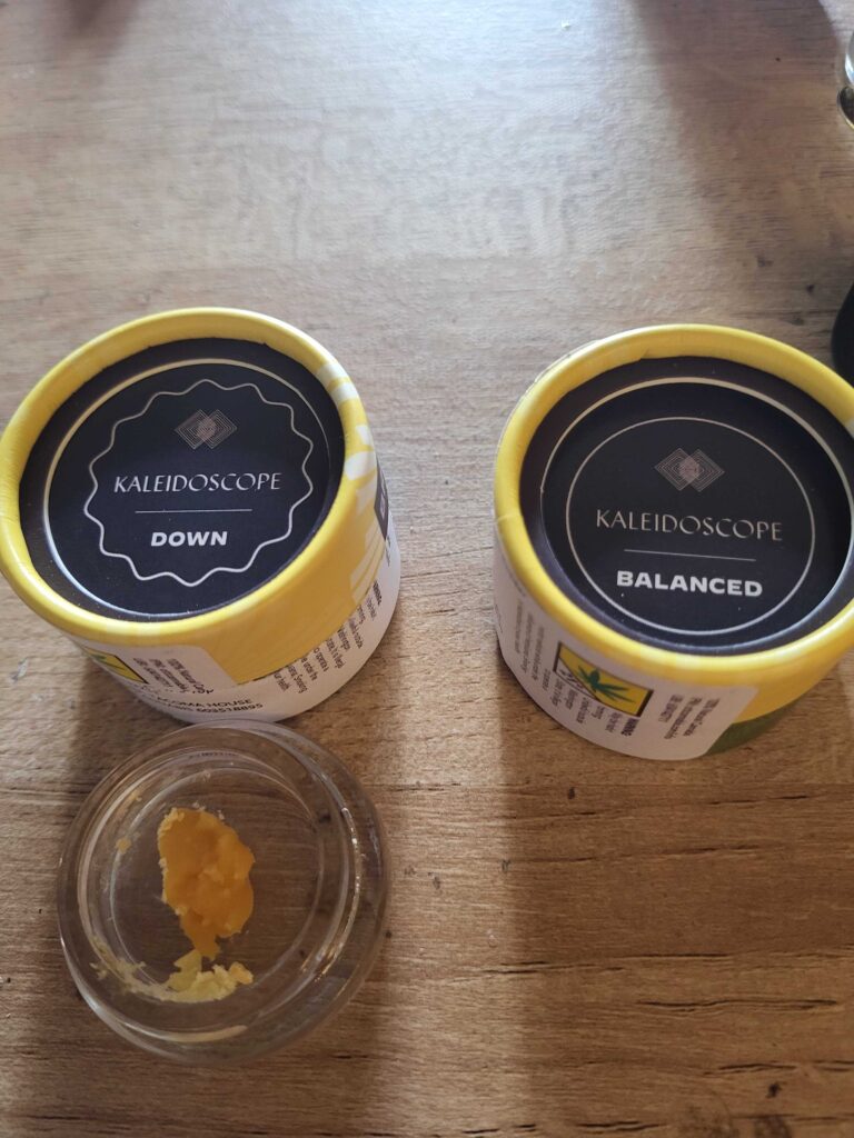 Two grams of concentrates in their containers, on a table.